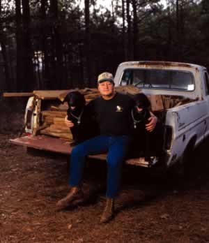 Jerry McCollum, flanked by hunting dogs Casey and Hannah, at his home at Wildwood Farms in Madison, Georgia. Photo by Richard T. Bryant. Email richard_t_bryant@mindspring.com.